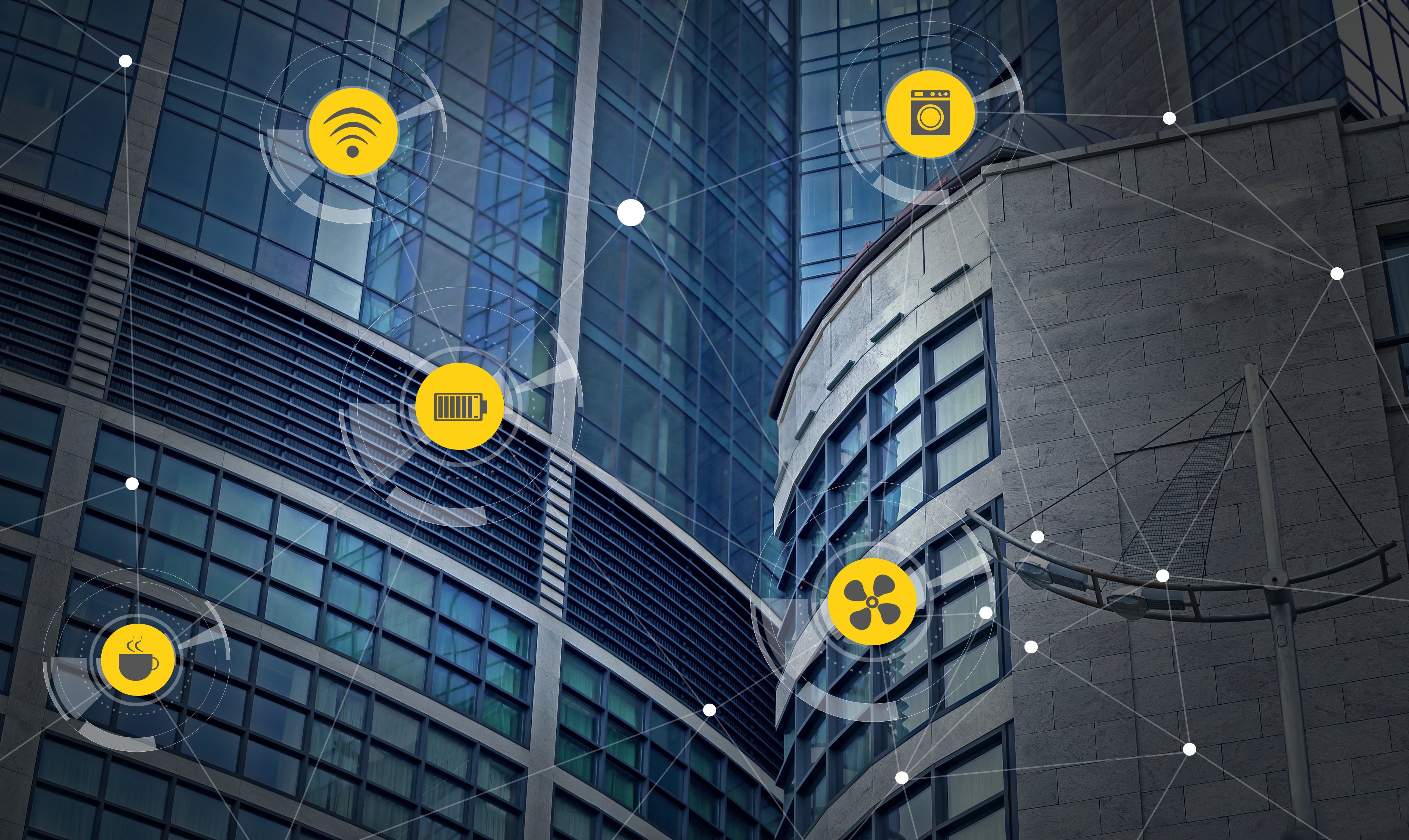 building system icons connected over a skyscraper representing the importance of BMS cyber security