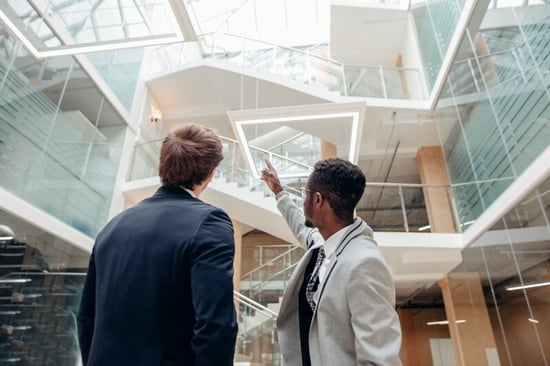 An engineer explains to a commercial property owner how to design a smart building out of a standard office space.