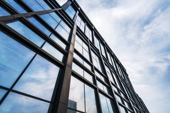 Blue skies over a tall building with the weather forecast looking clear with high-level clouds.